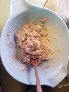 Adding water and yeast to flour